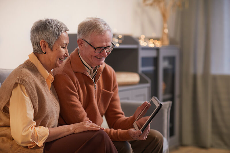 Safety, Suites, & Square Feet: Renovating for the Senior Years Senior couple browsing home financing options for their home renovation